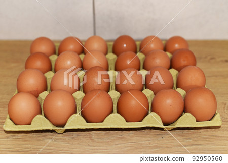 Chicken egg in box. Natural organic eggs in cardboard package on table in kitchen. 92950560