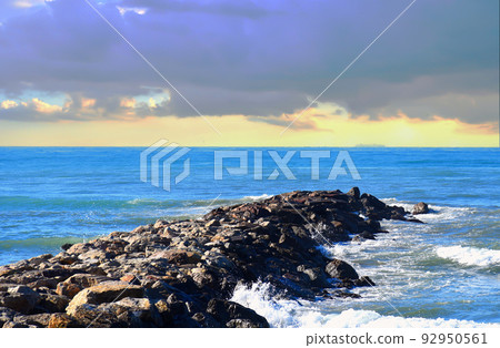 Breakwater with waves in sea. Waves at the stone pier. Breakwater with waves in sea. Waves at the stone pier. 92950561