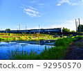 Train on bridge over river in wild. Passenger train passes over a railway bridge over a wild river 92950570