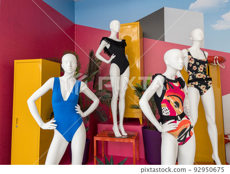 Mannequins in colorful swimsuits in clothes shop. Summer vacation. Fashion model. Colorful vacation concept 92950675