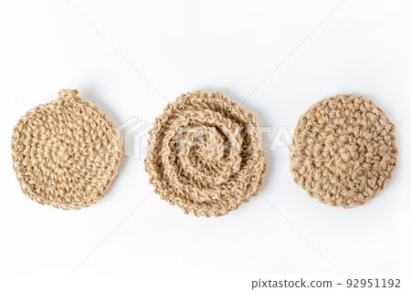 Natural washcloth made of craft thread for washing dishes. The concept of waste-free production , zero waste on white background isolated  92951192