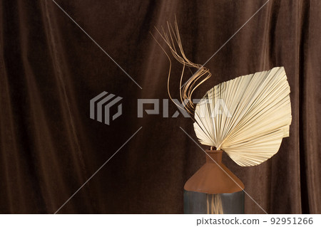 Dry sugar palm leaves in original modern vase on the neutral pastel background. Interior detail for your purposes, copy space. Dry sugar palm leaves in original modern vase on the neutral pastel background. Interior detail for your purposes, copy space. 92951266