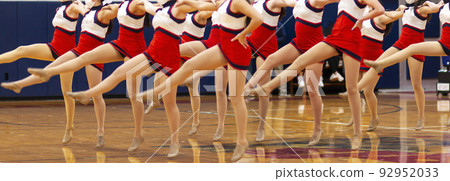 High school kickline girls performing in a gym 92952033