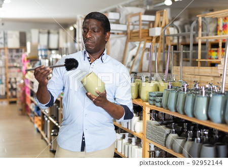 African American shopper choosing bathroom accessories in store African American shopper choosing bathroom accessories in store 92952144