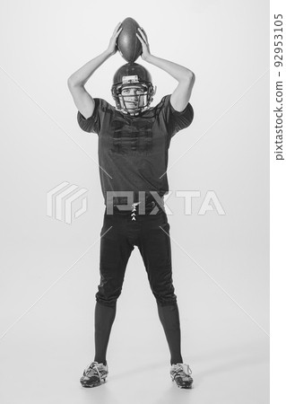 Portrait of young man, american football player posing. Black and white photography. College championship Portrait of young man, american football player posing. Black and white photography. College championship 92953105