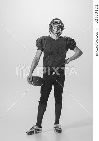 Portrait of young man, american football player posing. Black and white photography. Smiling, laughing, Winning championship Portrait of young man, american football player posing. Black and white photography. Smiling, laughing, Winning championship 92953121
