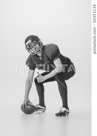 Portrait of young smiling man, american football player posing. Black and white photography. After winning match 92953139