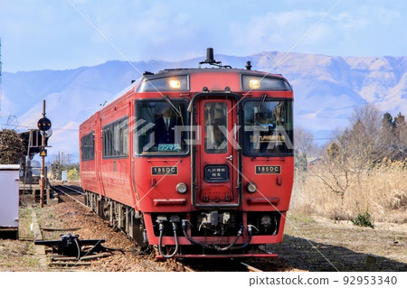 Trans-Kyushu Limited Express departing from Aso Station with Mt. Aso in the background Trans-Kyushu Limited Express departing from Aso Station with Mt. Aso in the background 92953340