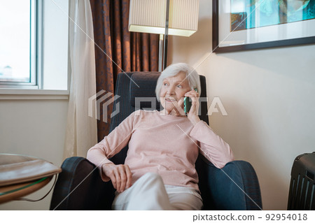 Short-haired elegant lady talking on the phone Short-haired elegant lady talking on the phone 92954018