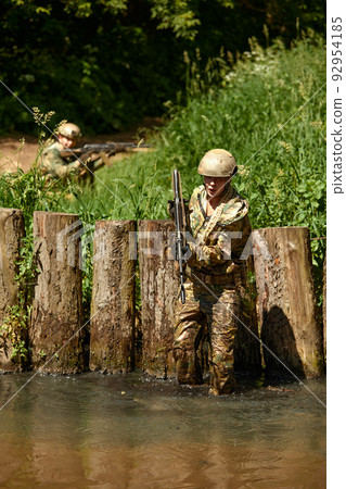 Soldiers game on military training ground battle camp. Action. Operation Trainer giving training to military soldiers at boot camp 92954185