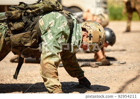 Soldiers game on military training ground battle camp. Action. Operation Trainer giving training to military soldiers at boot camp 92954211