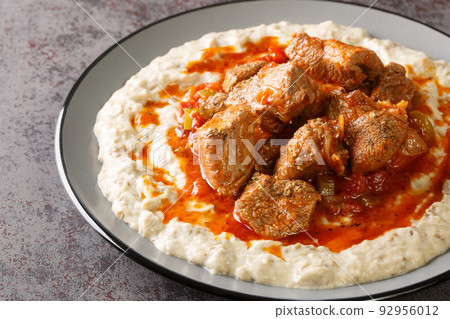 Turkish Hunkar Begendi meat on a bed of baked eggplant with bechamel closeup in the plate. Horizontal Turkish Hunkar Begendi meat on a bed of baked eggplant with bechamel closeup in the plate. Horizontal 92956012