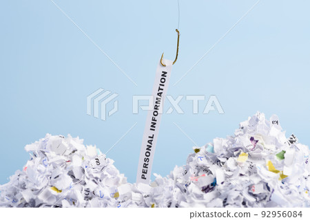 Words Personal information hooked on fishing hook pulled from pile of shredded documents Words Personal information hooked on fishing hook pulled from pile of shredded documents 92956084