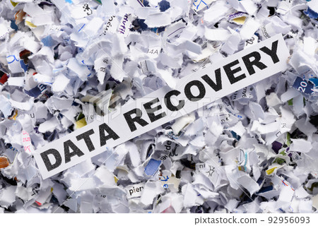 Words Data recovery on top of heap of cross shredded paper concept top view Words Data recovery on top of heap of cross shredded paper concept top view 92956093