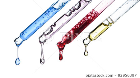 Cosmetic pipette droppers with different colored skincare serum and hanging liquid drop, isolated Cosmetic pipette droppers with different colored skincare serum and hanging liquid drop, isolated 92956397