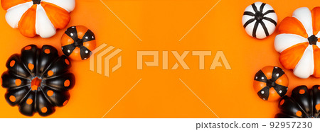 Halloween banner with pumpkins in different colors and sizes. Place for text. Copy space. Flay lay. Top view. Layout for design. Orange background. Halloween card. Halloween banner with pumpkins in different colors and sizes. Place for text. Copy space. Flay lay. Top view. Layout for design. Orange background. Halloween card. 92957230