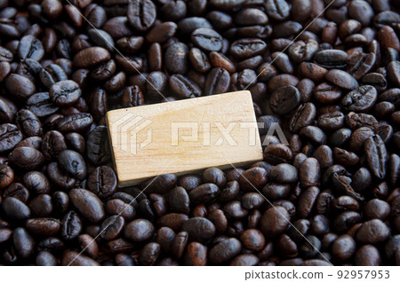 Blank wooden block surrounded by coffee bean. Copy space 92957953