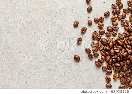 Advertising coffee poster. Stone background with scattered roasted beans Advertising coffee poster. Stone background with scattered roasted beans 92958336