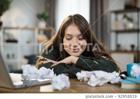 Indoor picture of smiling and tired woman sleeping on the table. Indoor picture of smiling and tired woman sleeping on the table. 92958819