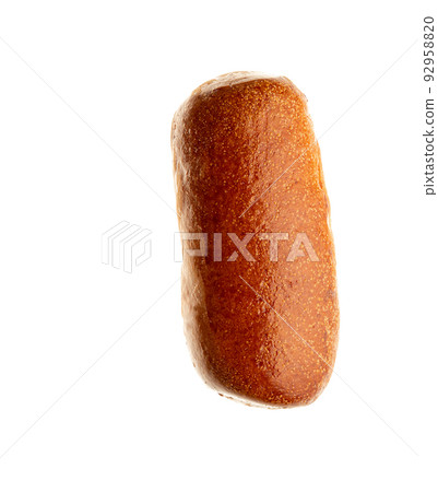 Top view of one fresh baked wheat bun for hot dog isolated on white background. Close-up of a single whole bread roll. Top view. 92958820