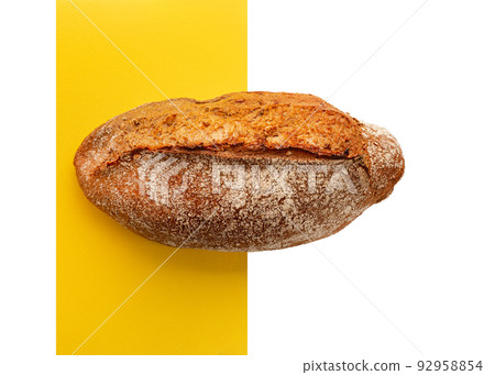 Artisan bread on white background with yellow line. One loaves on wheat bread on white background. Artisan bread on white background with yellow line. One loaves on wheat bread on white background. 92958854
