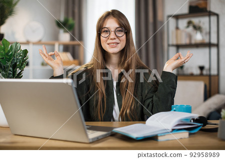 Pretty female freelance meditating with open eyes. Pretty female freelance meditating with open eyes. 92958989