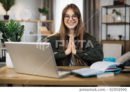 Pretty female freelance meditating with open eyes. 92958990