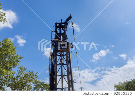 On a private plot of land, a portable hydraulic water well drilling rig with water extraction On a private plot of land, a portable hydraulic water well drilling rig with water extraction 92960130