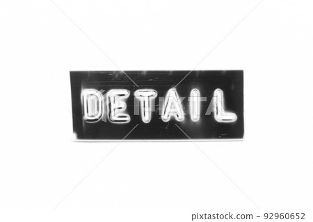 Black color banner that have embossed letter with word detail on white paper background 92960652