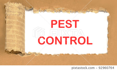 PEST CONTROL the inscription appearing behind the torn cardboard paper 92960764