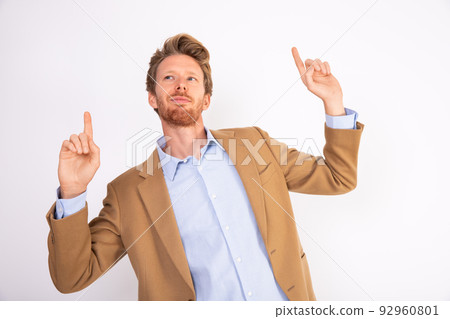 Portrait of relaxed young businessman listening to music 92960801