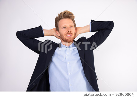 Portrait of relaxed businessman standing with hands behind head 92960804