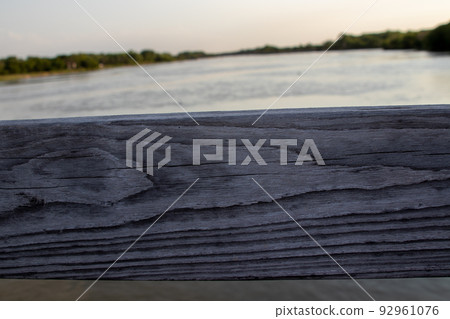 View of Platte river thru wooden Bridge rails View of Platte river thru wooden Bridge rails 92961076