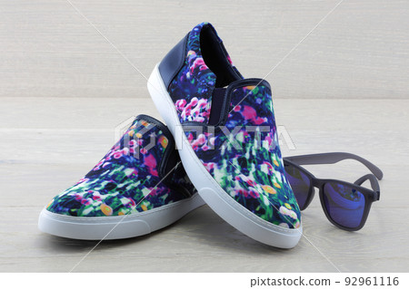 Colourful pumps on wood background with sunglasses 92961116