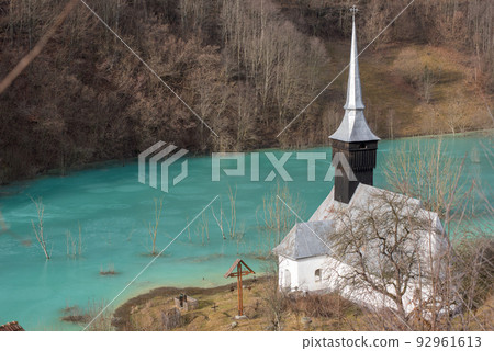 Toxic waste waters from a copper and gold mine submerge village. Abandoned orthodox church on lakeside Toxic waste waters from a copper and gold mine submerge village. Abandoned orthodox church on lakeside 92961613