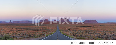 Scenic Road in the Dry Desert with Red Rocky Mountains in Background. Scenic Road in the Dry Desert with Red Rocky Mountains in Background. 92962027