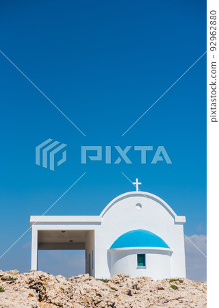Traditional white chapel with a blue roof on the seaside. Agioi Anargyroi, Cyprus Traditional white chapel with a blue roof on the seaside. Agioi Anargyroi, Cyprus 92962880