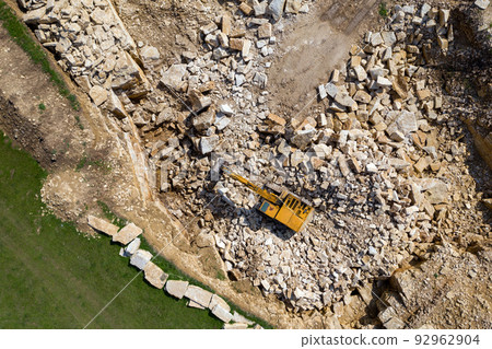 Aerial view of excavator working in a limestone quarry Aerial view of excavator working in a limestone quarry 92962904