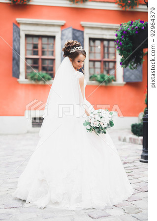 Portrait of stunning bride with long hair posing with great bouquet 92964379