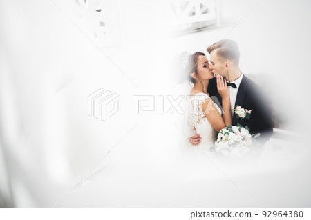 Perfect wedding couple holding luxury bouquet of flowers 92964380