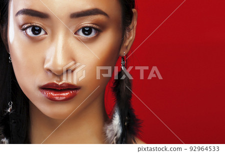 beauty young asian girl with fashion make up on red background , beauty stylish look close up beauty young asian girl with fashion make up on red background , beauty stylish look close up 92964533