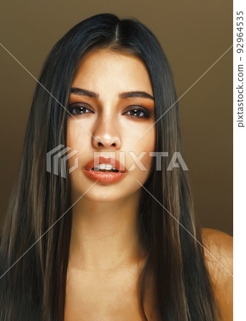 cute happy young indian woman in studio closeup smiling on brown background, fashion beauty lifestyle people concept close up cute happy young indian woman in studio closeup smiling on brown background, fashion beauty lifestyle people concept close up 92964535