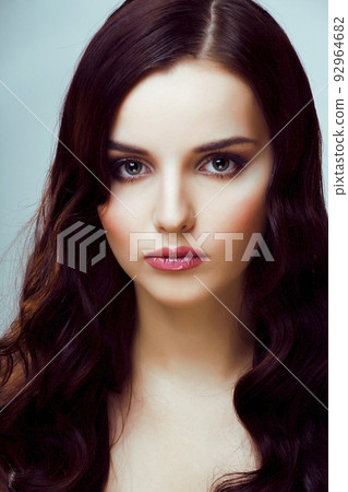 young pretty woman with hairstyle waves, luxury fashion make up look on white background close up 92964682