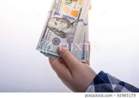 Hands holding cash USD dollar banknotes.  Currency,  Cash, Bill Concept 92965179