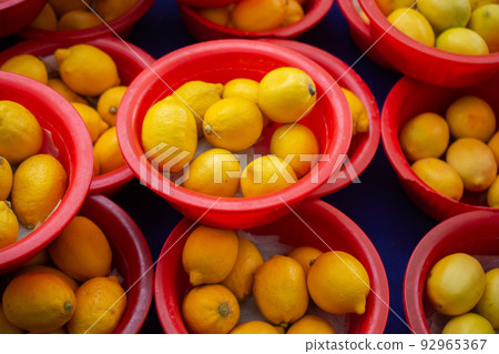 Pile of ripe yellow lemons in summer market for sale, for background. Pile of ripe yellow lemons in summer market for sale, for background. 92965367