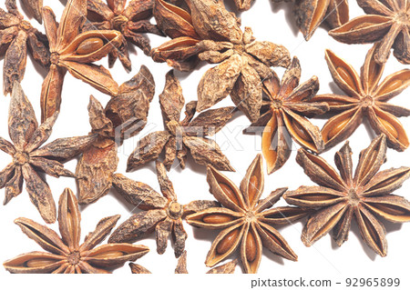 A group of star anises isolated on white background. Dried star anise spice fruits top view. A group of star anises isolated on white background. Dried star anise spice fruits top view. 92965899