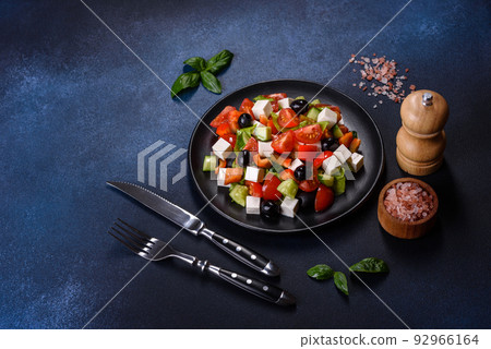 Greek salad with fresh vegetables, feta cheese and black olives 92966164