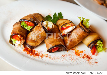 Eggplant rolls with cheese, tomatoes and lettuce Eggplant rolls with cheese, tomatoes and lettuce 92966276