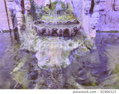 in the oceanarium there is a large stone waterfall with flowing water. stone buddha temple, many-faced god, a zone of unity with flora and fauna in the oceanarium there is a large stone waterfall with flowing water. stone buddha temple, many-faced god, a zone of unity with flora and fauna 92966323