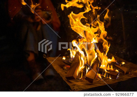 person making a campfire on a bonfire person making a campfire on a bonfire 92966877